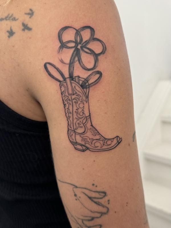 Fineline Cowgirl Boot Tattoo With Abstract Flower