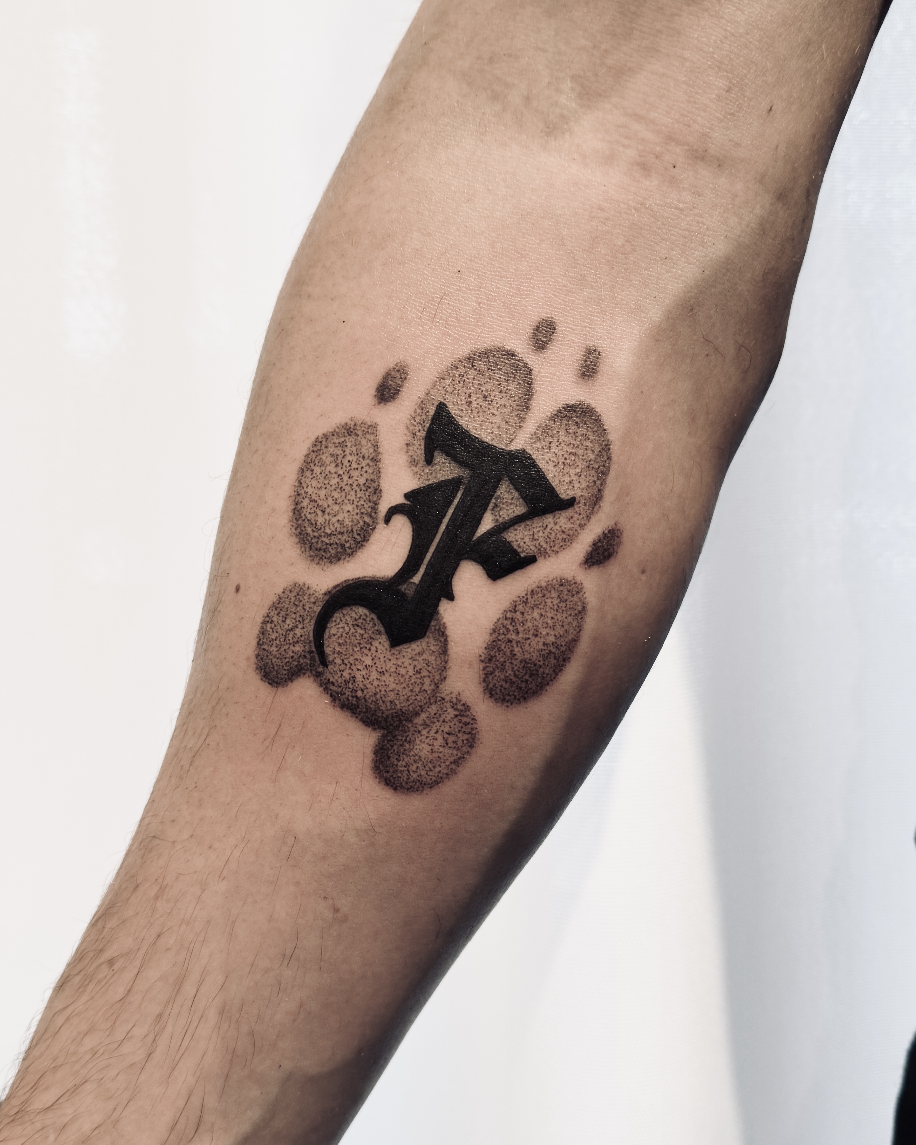 Blackwork Dog Footprint Tattoo